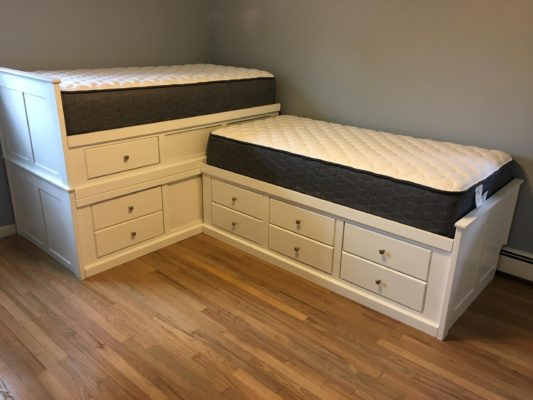 Modified Archbold beds to form an L-shaped custom alder storage bed in white lacquer for a customer in Oradell, NJ