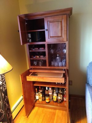 Custom built maple liquor cabinet featured in a Brandywine finish for a customer in North Arlington, NJ